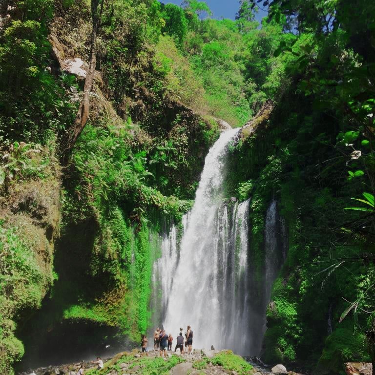 Discover the enchanting Tiu Kelep Waterfall in North Lombok, where pristine waters flow amidst tropical greenery, offering a serene escape